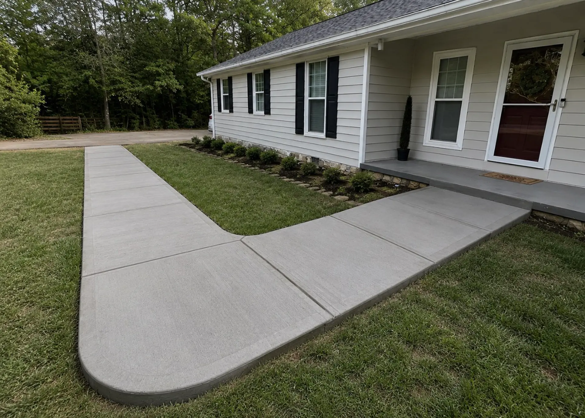 Freshly poured concrete driveway by Mind & Vision Construction